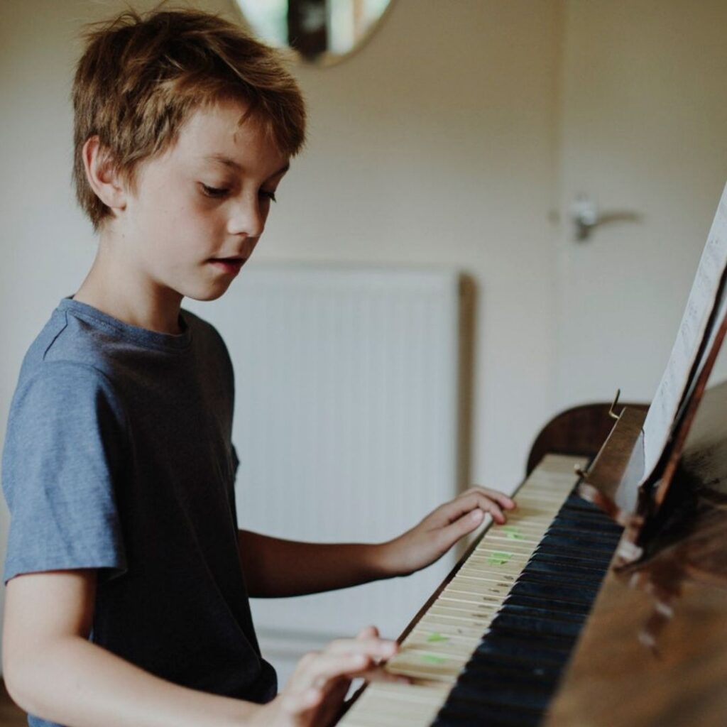 Boy learning piano